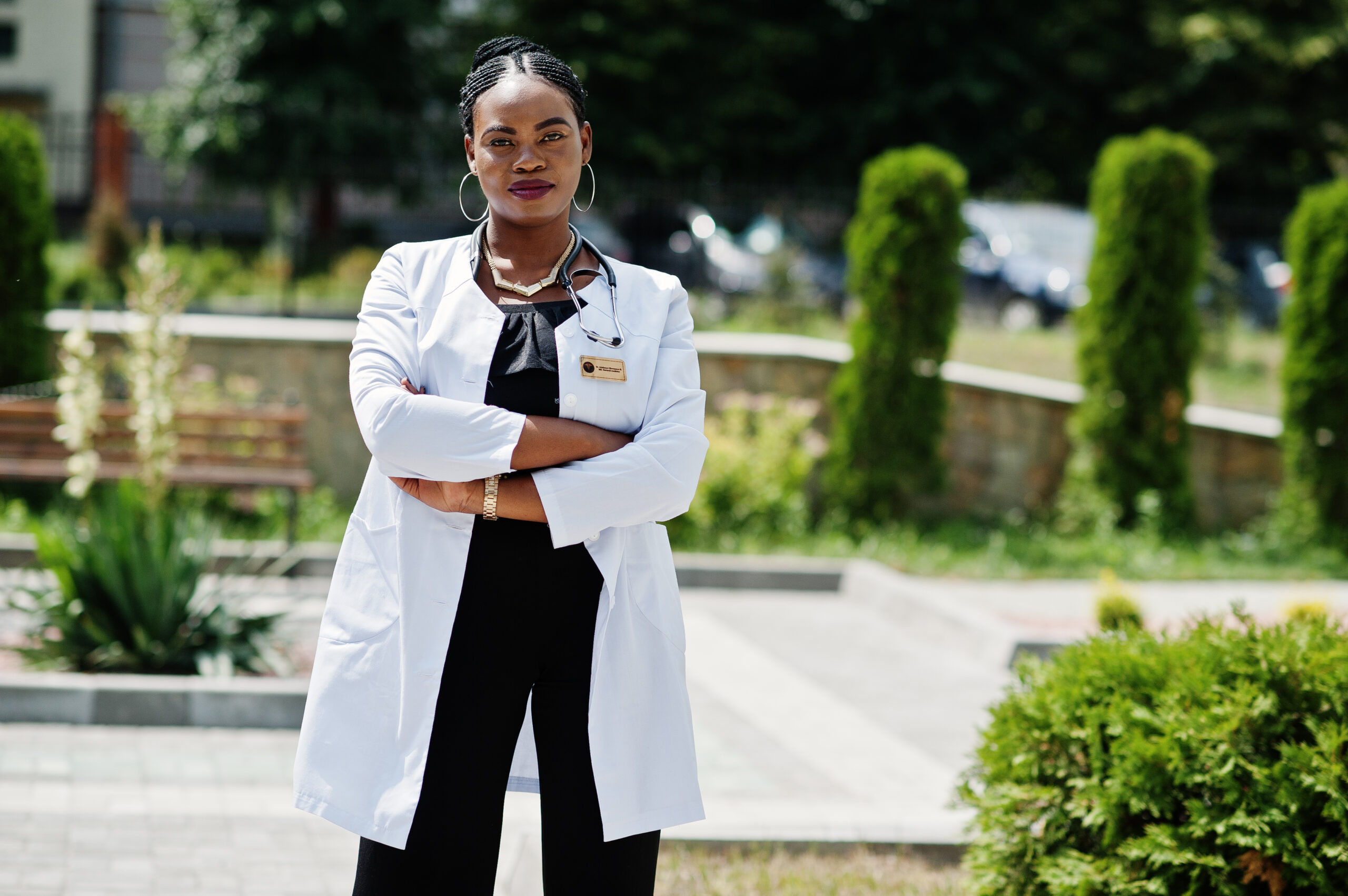 African american doctor female at lab coat with stethoscope outdoor.